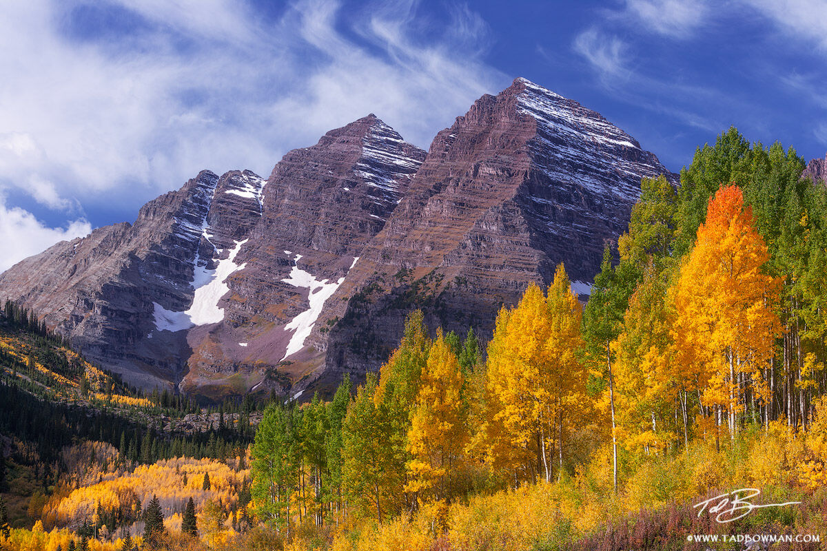 This Colorado mountain picture depicts early morning light on the Maroon Bells mountains with colorful fall aspen trees.