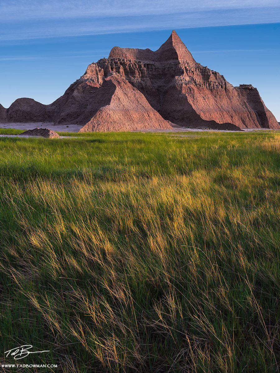 This national park photo depicts sunrise on a rock pyramid in the Badlands National Park, South Dakota