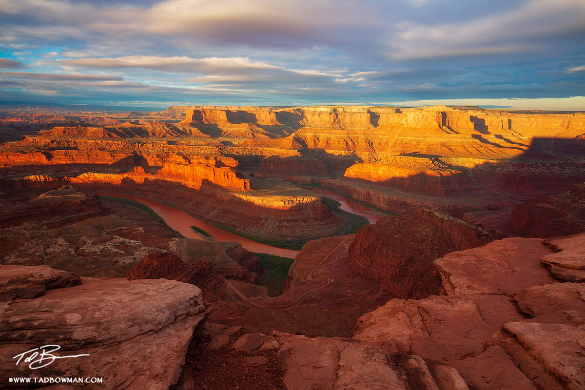 This southwest picture depicts a winter sunrise casting warm light on the red rocks from Dead Horse Point Overlook.