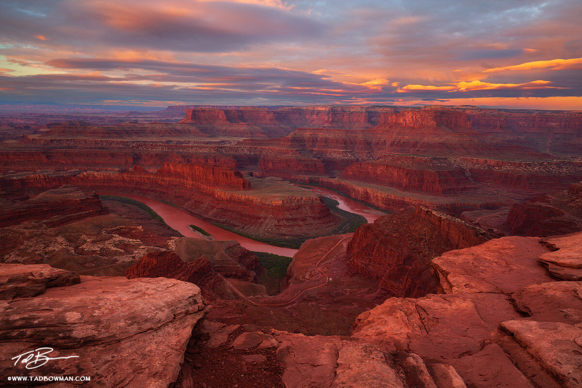 This Utah southwest picture depicts sunrise with pink clouds and red canyons from Dead Horse Point Overlook.