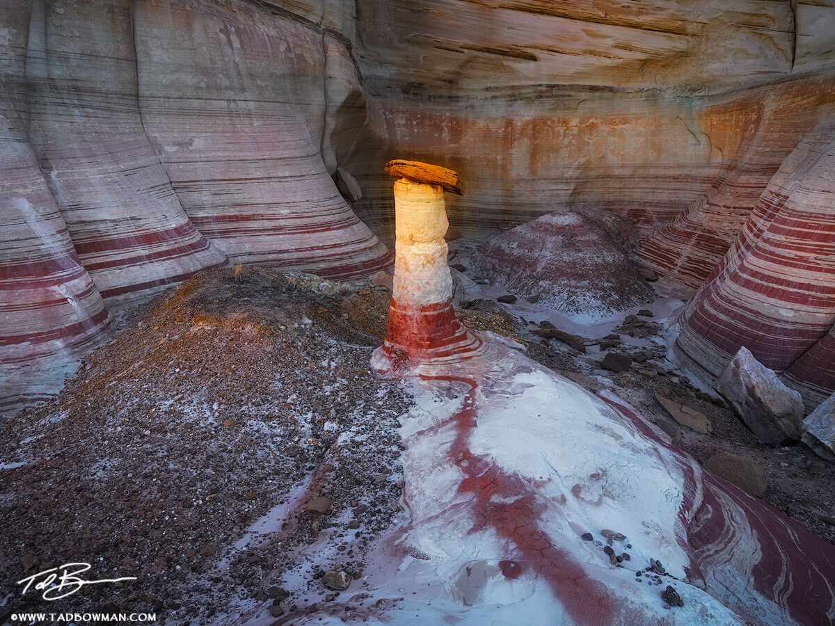 This desert photo depicts a hoodoo receiving last rays of light in a remote canyon in Southern Utah