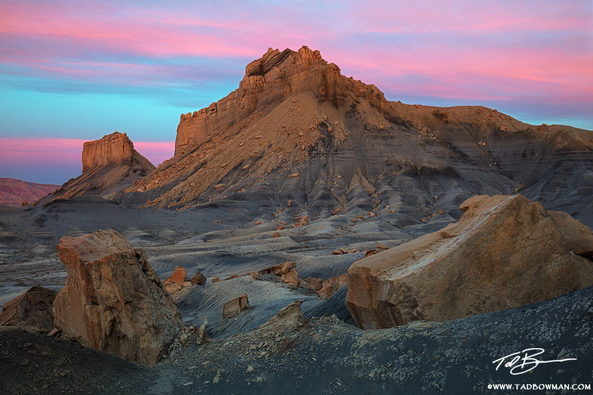 This Utah photo depicts a pink sunrise on sandstone formations in the Grand Staircase-Escalante National Monument