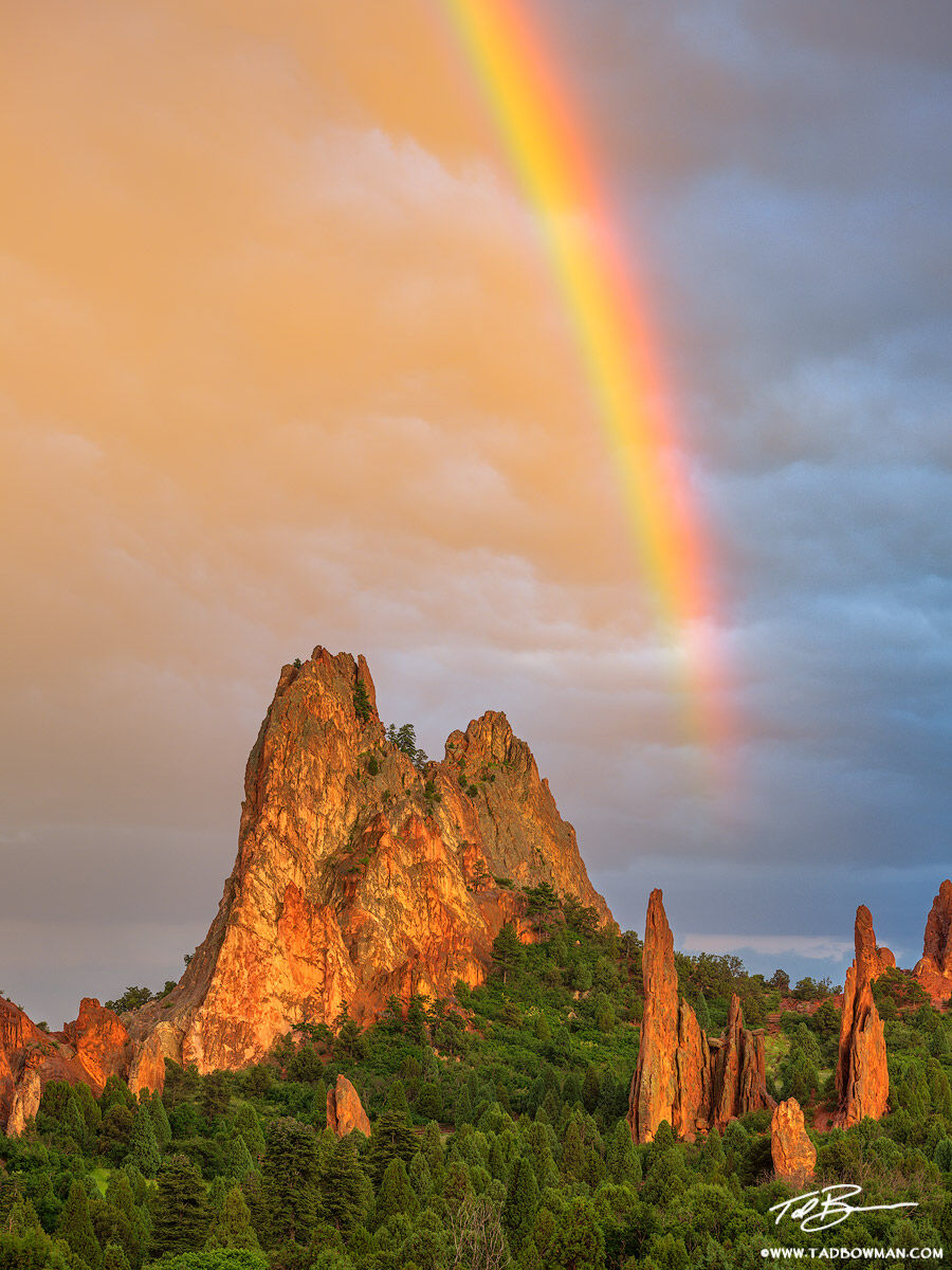 This Garden of the Gods photo depicts sunset over South Gateway rock with colorful clouds and a rainbow as driving rain and hail...