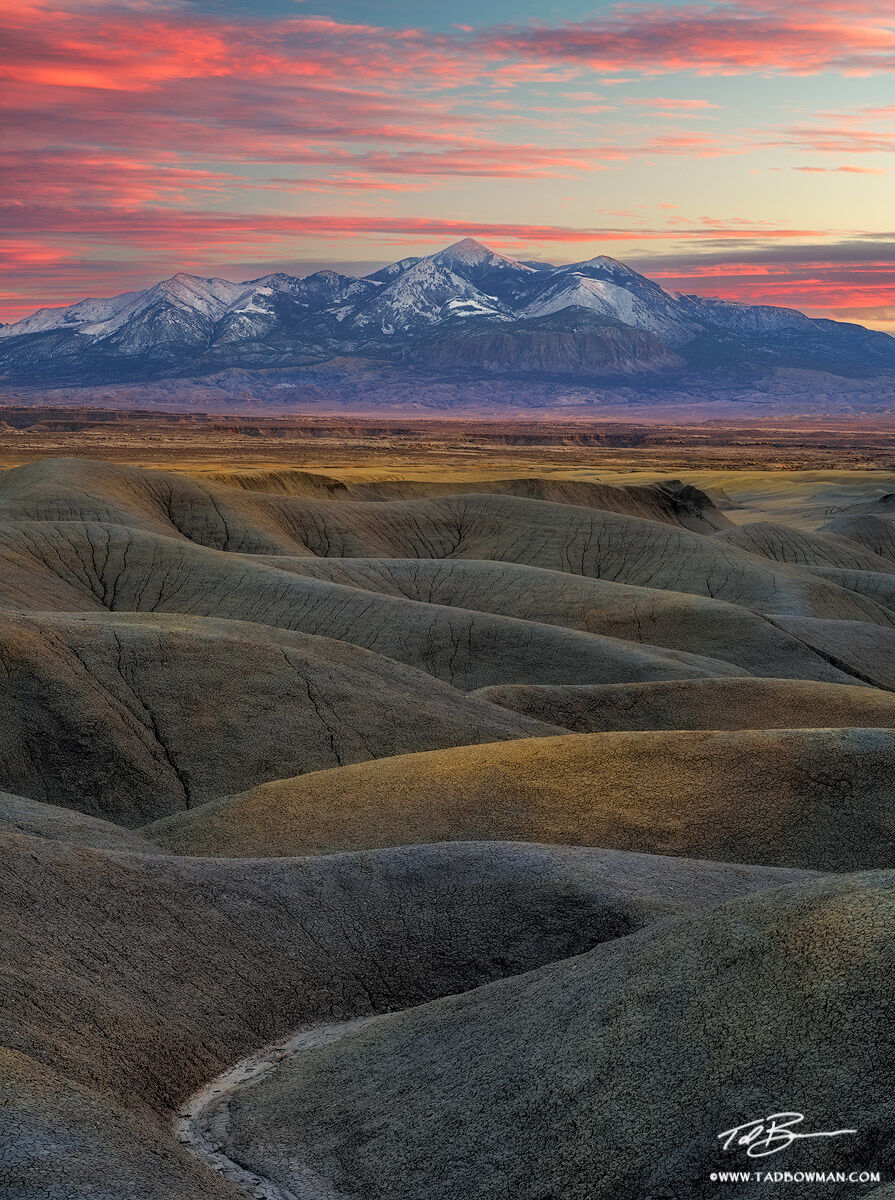 This desert photo depicts a colorful sunset over the Henry Mountains in southern Utah