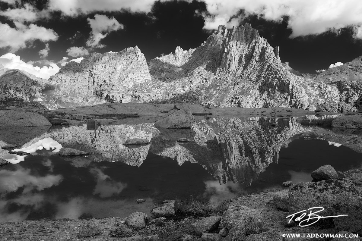 This Colorado mountain photo depicts a black and white view of Jagged Mountain reflecting in an alpine tarn in the Weminuche...