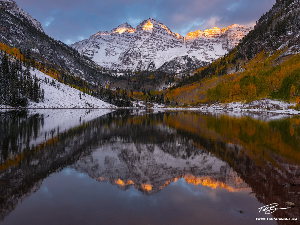 This Colorado mountain picture depicts autumn foliage with the Maroon Bells mountains reflecting in Maroon Lake