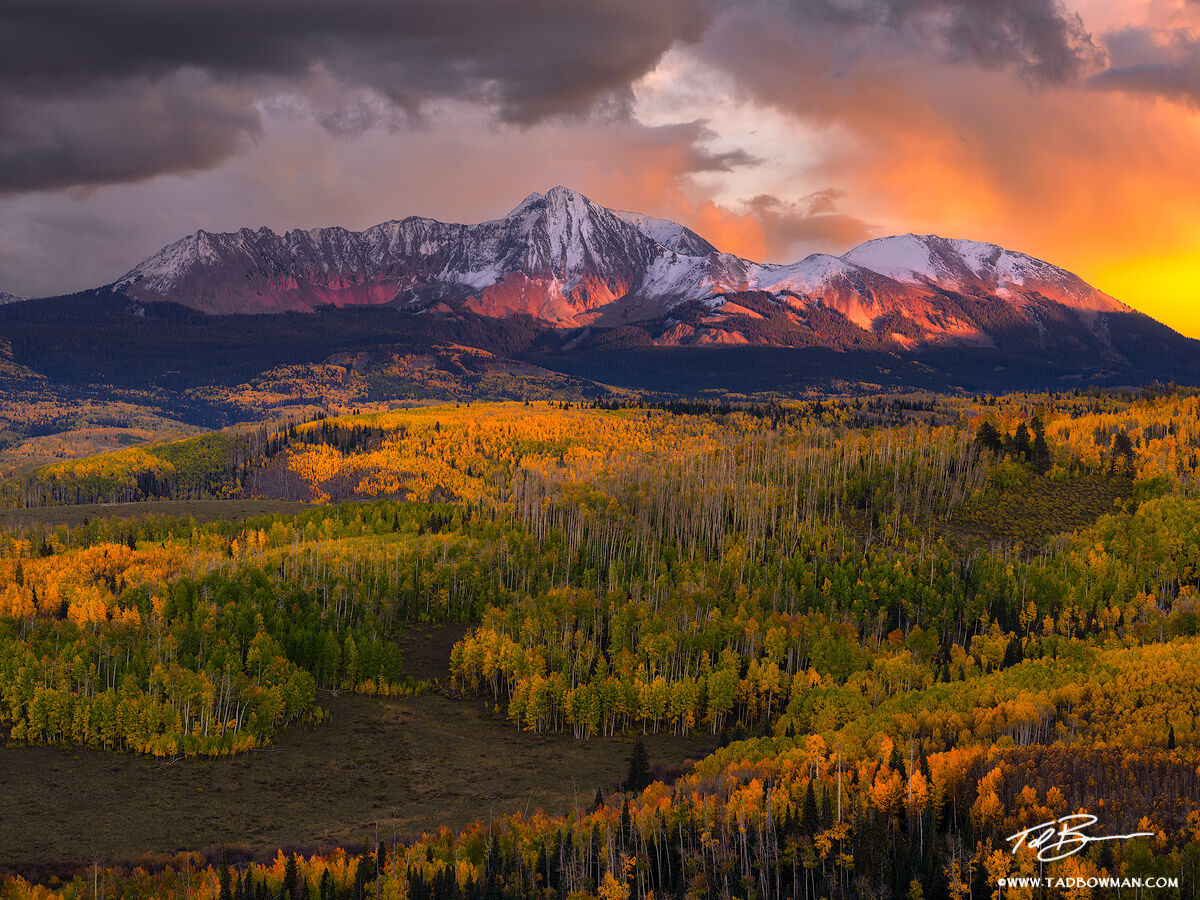 This Colorado mountain photo depicts the San Miguel Mountains with rich warm colors at sunset with colorful fall foliage in the...