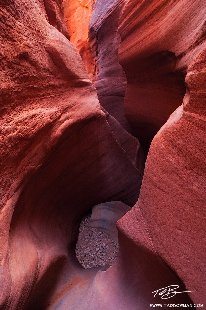 This Utah picture depicts interesting rock formations including a small arch in a remote slot canyon.