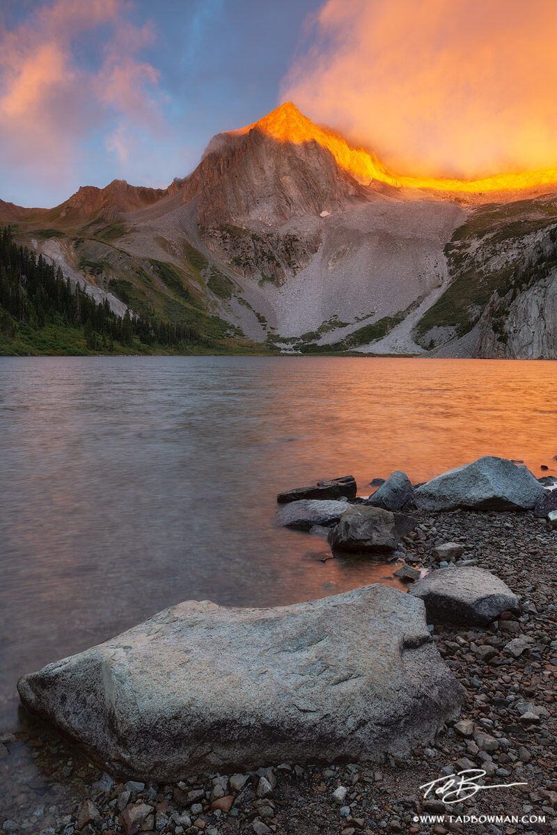 This Colorado photo depicts sunrise with dramatic light on Snowmass Peak from Snowmass Lake