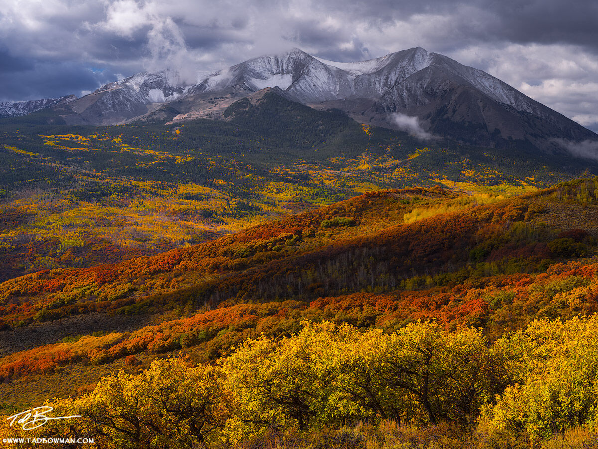 This Colorado mountain photo depicts stormy conditions brewing over Mount Sopris surrounded by fall foliage