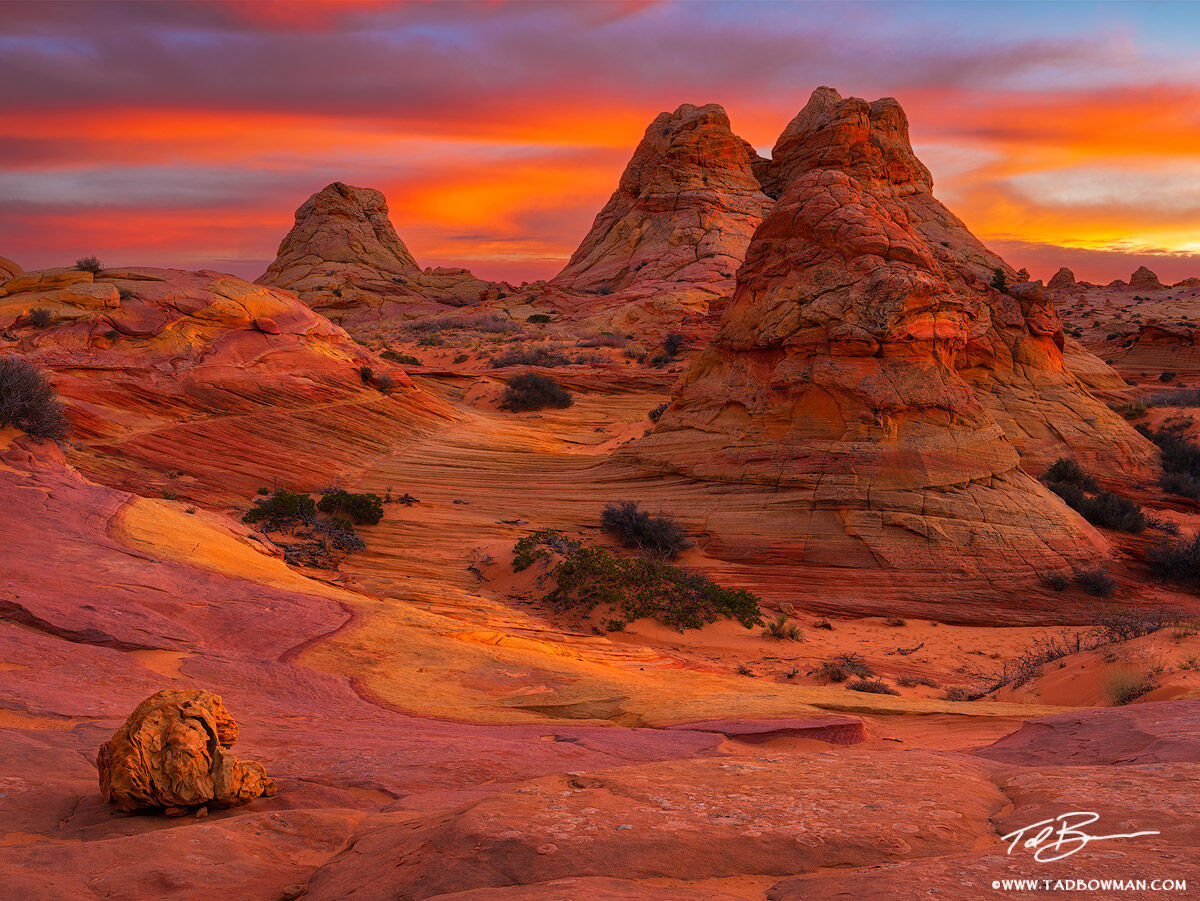 This Arizona desert photo depicts sunset over&nbsp;three sandstone rock formations resembling Teepees